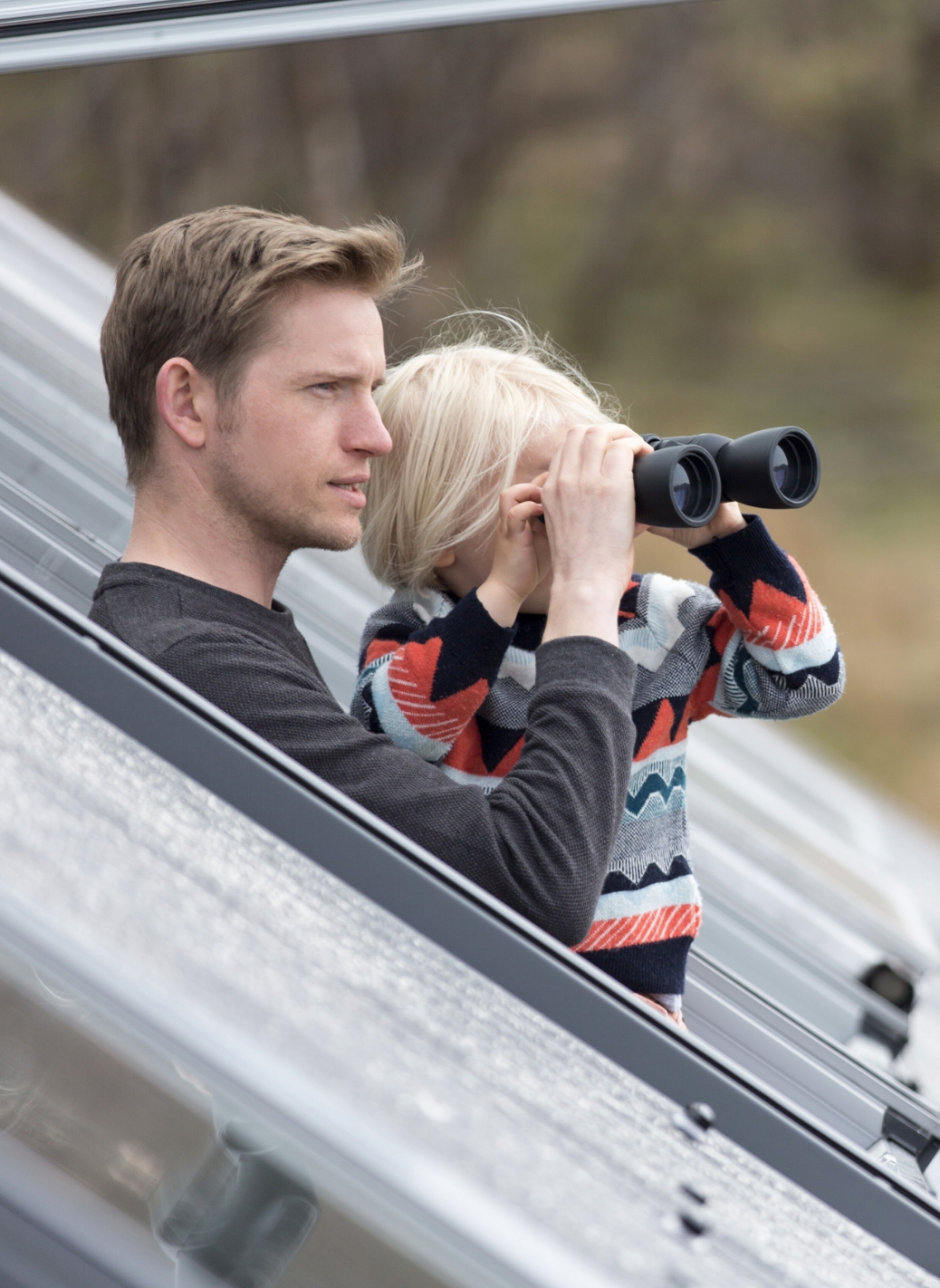 Child excitedly pointing at birds outside window